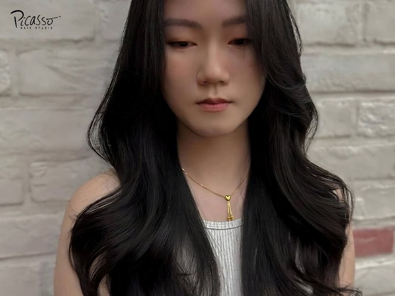 Asian woman with black hair and a korean wave perm