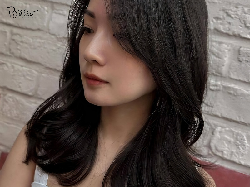 Asian woman with visibly permed black hair