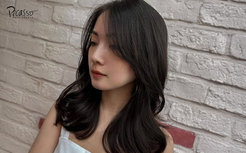 Loose curls hairstyle on an Asian woman.