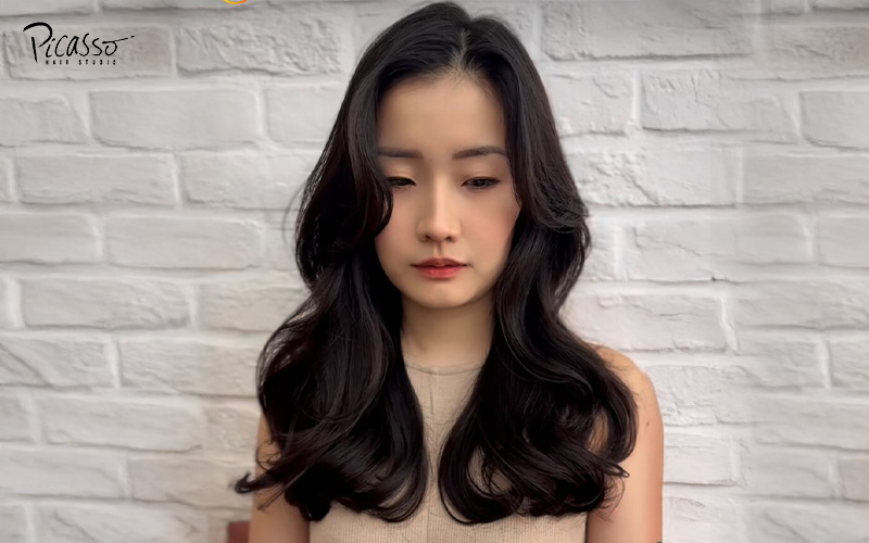 Permed hairstyle on an Asian woman.