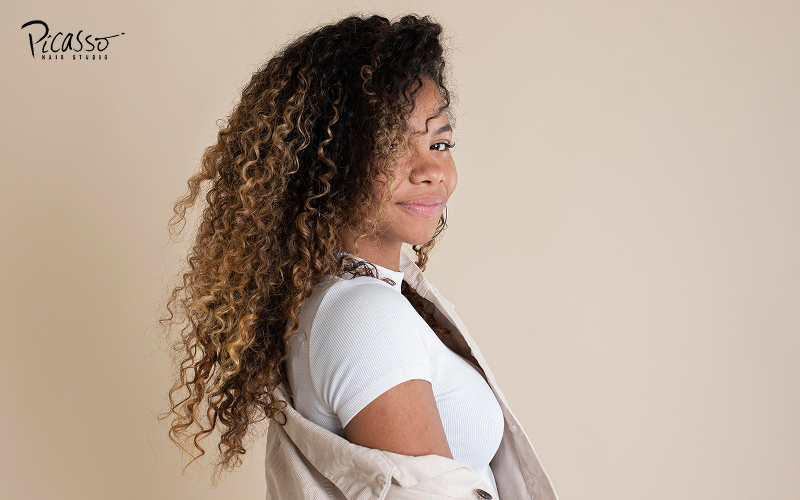 Woman with a stylish curly hair perm.